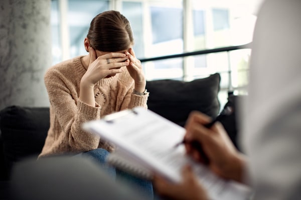 Depressed woman having a psychotherapy session in a doctor's office