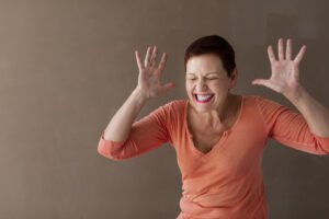 angry woman squeezing a piece of paper