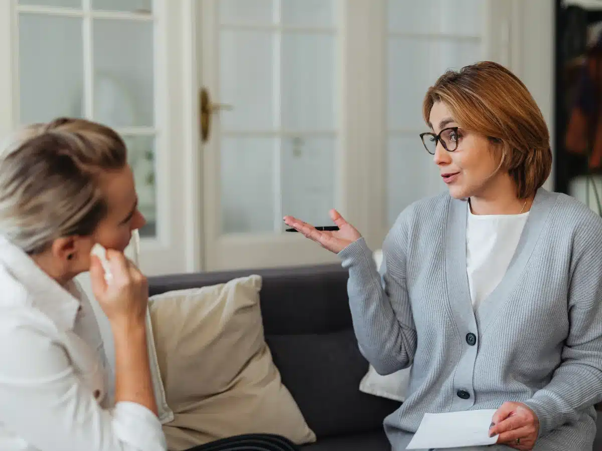 a woman counselling a troubled lady